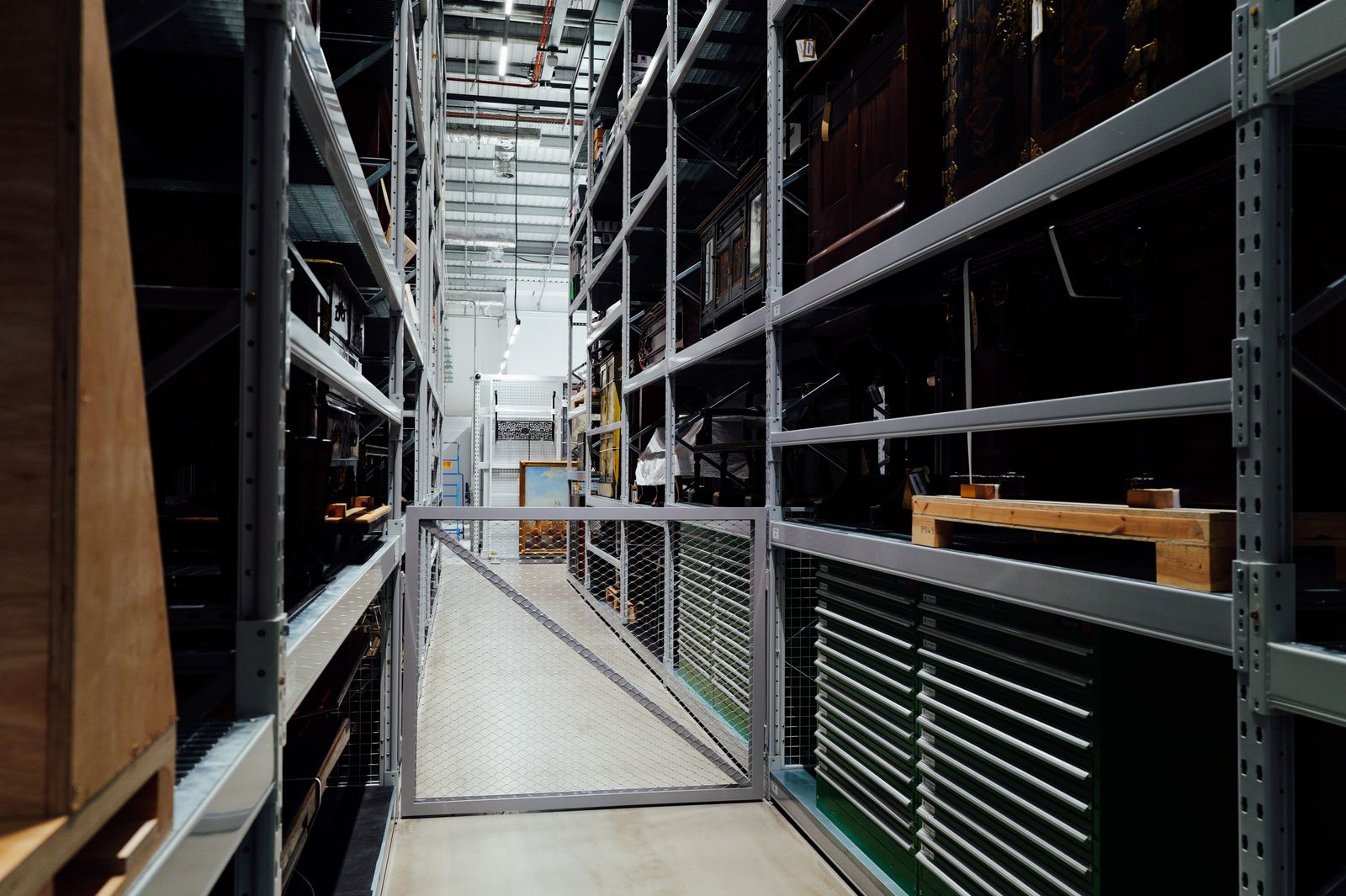 Interior of a high bay distribution warehouse with racking and overhead lighting